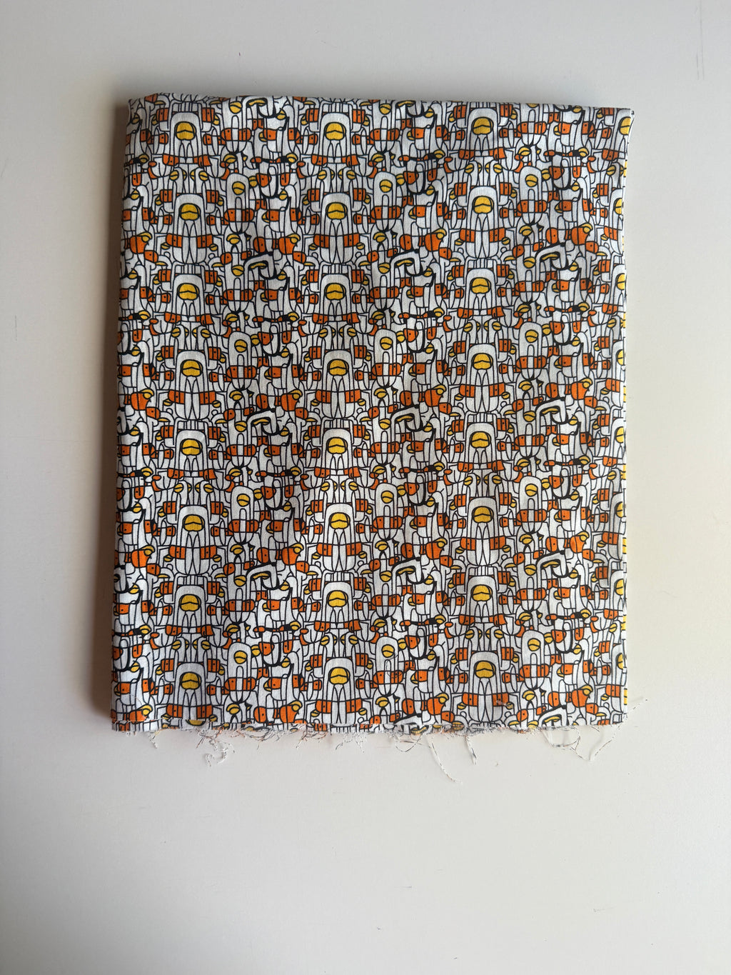 Abstract print stylized human figures in orange, yellow, and black cotton