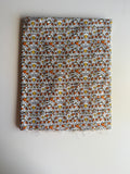 Abstract print stylized human figures in orange, yellow, and black cotton