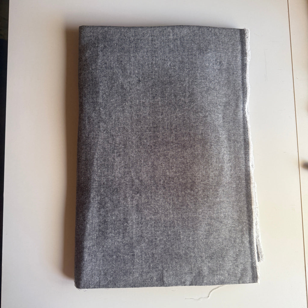 Grey textured fabric with a subtle speckled pattern