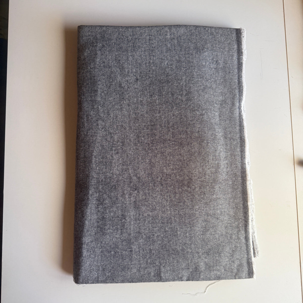 Grey textured fabric with a subtle speckled pattern