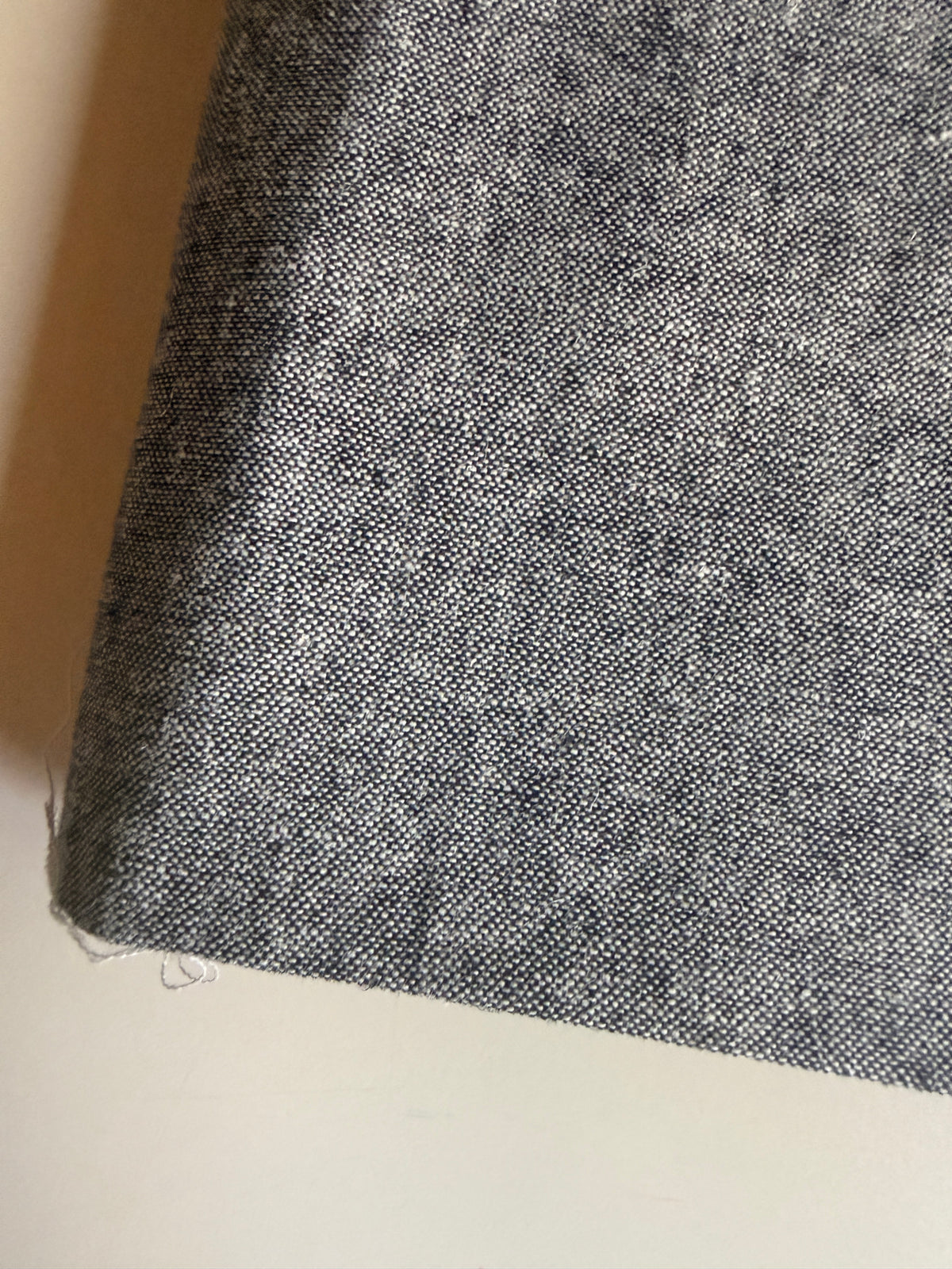 Grey textured fabric with a subtle speckled pattern