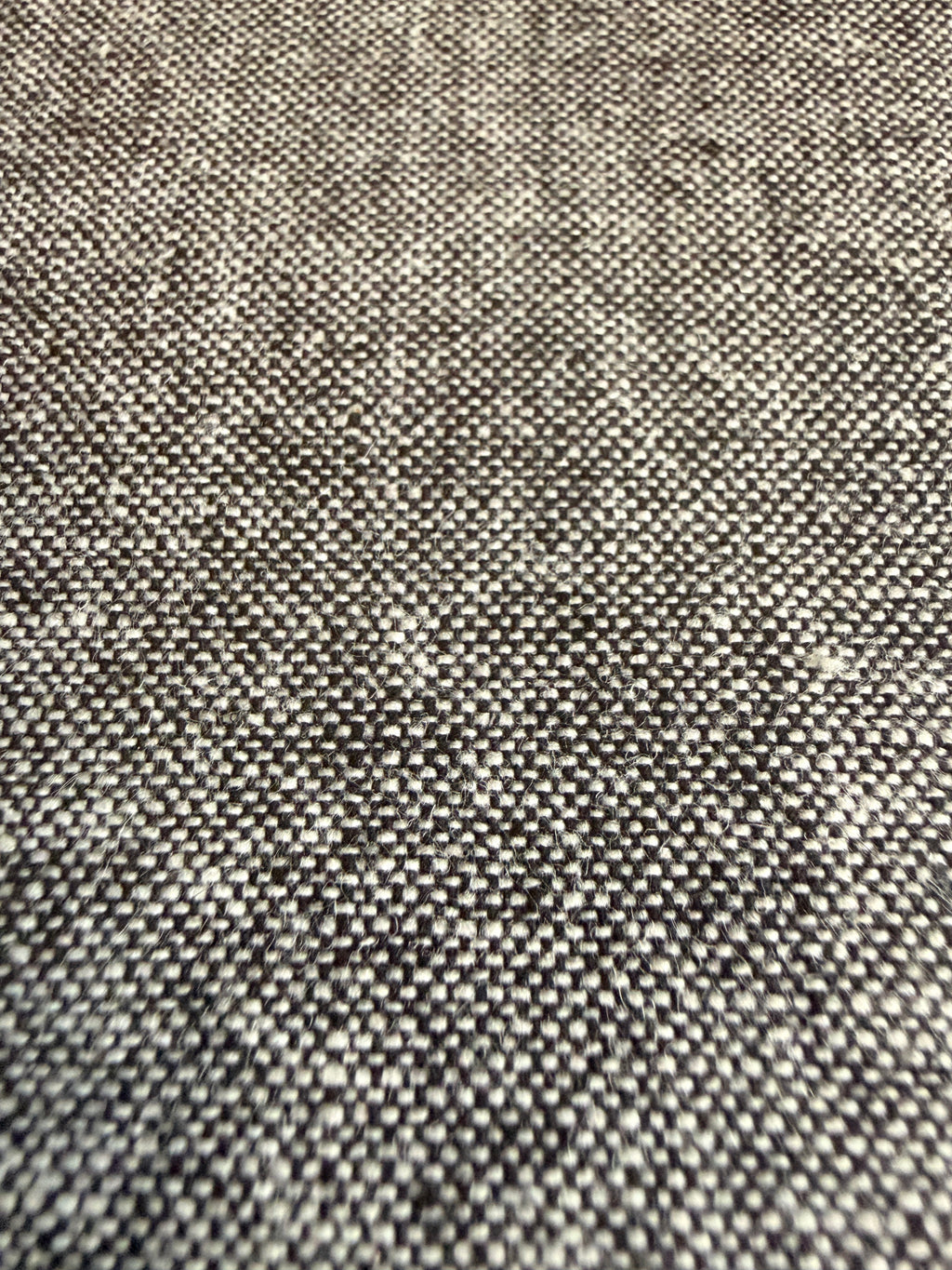 Grey textured fabric with a subtle speckled pattern