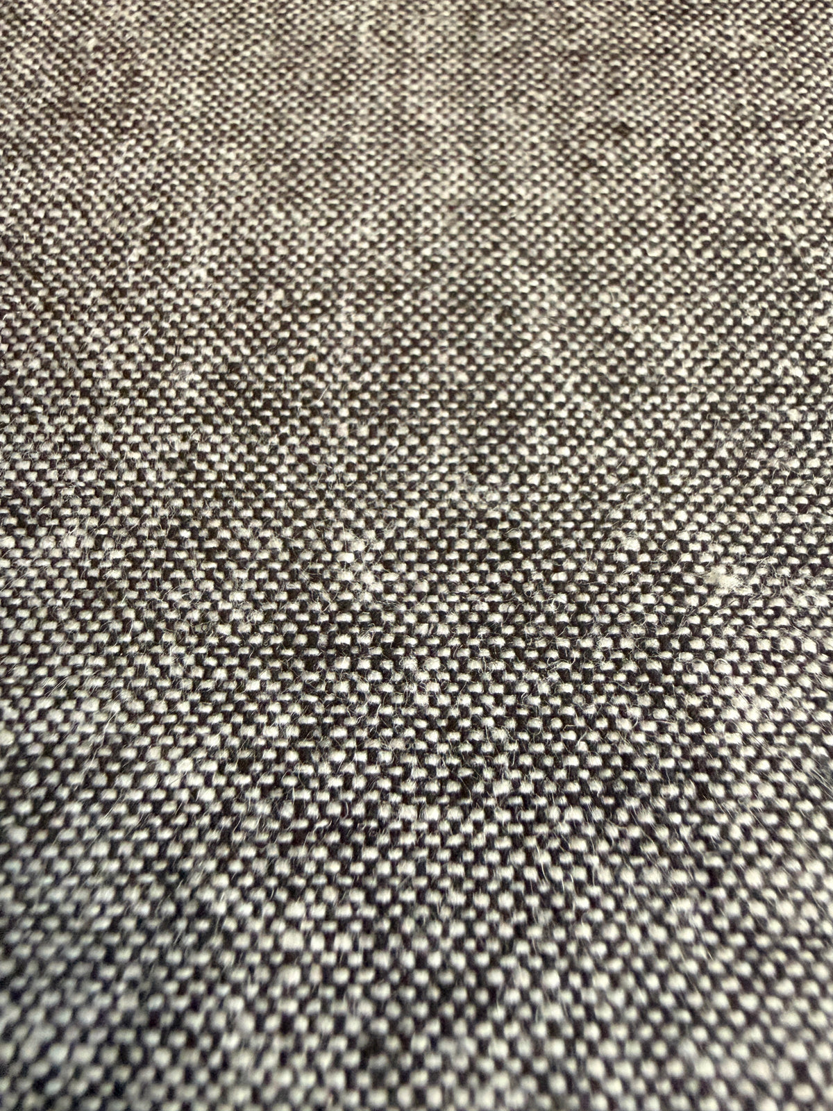 Grey textured fabric with a subtle speckled pattern