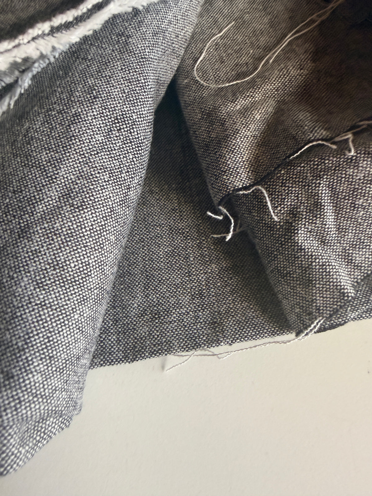 Grey textured fabric with a subtle speckled pattern