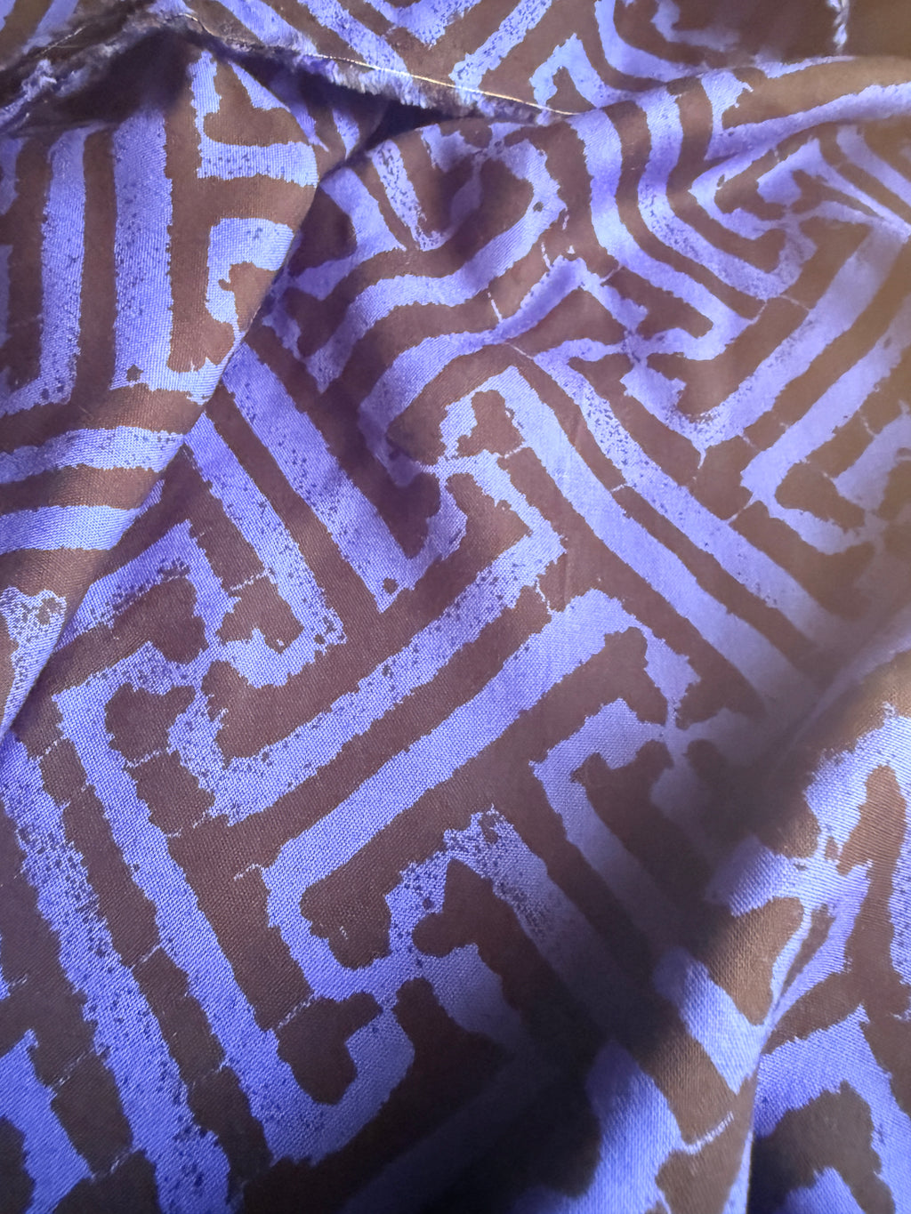 Black and blue geometric intricate maze-like motif
